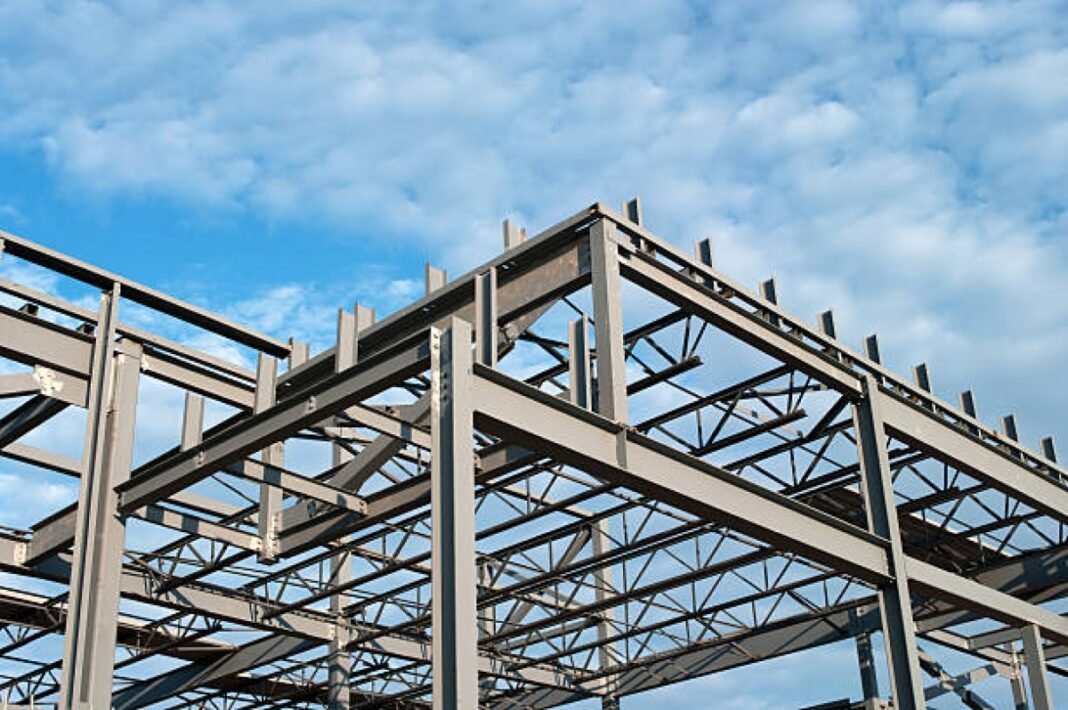 The steel frame of a new office building under construction.Similar Images. IMMT-led Consortium, Green Steel Initiative, Hydrogen-based DRI, Carbon Emissions Reduction, Sustainable Steel-making, Ministry of Steel, National Green Hydrogen Mission, Sponge Iron Production, Electric Arc Furnaces, Fossil Fuel Phase-out, Environmental Sustainability, Innovation in Steel Sector, Global Leadership in Green Technologies, Industrial Sustainability, Carbon Neutrality