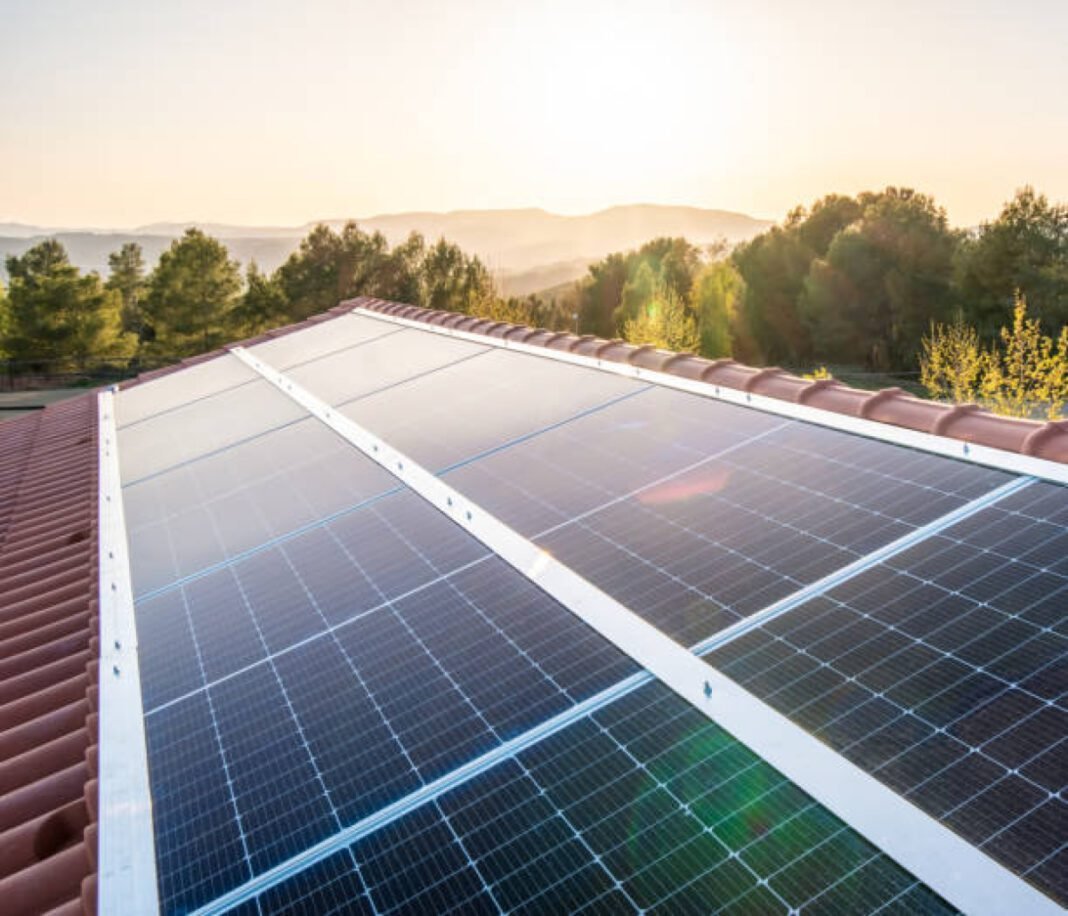 Side view of new solar panels on the roof of a house on a sunny day. North Western Railway, Bikaner Division, 2 MW solar project, rooftop solar systems, grid-connected, solar panels, power conditioning units.