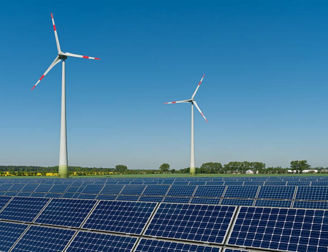Solar panels and wind turbines against a rapeseed field West Bengal, WBPDCL, O&M bids, rooftop solar project, 3.5 MW, solar energy, Rs 5.24 million, solar projects, Teesta Canal.