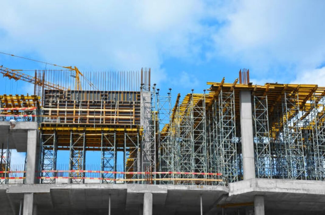 High-rise building construction site work with scaffolding India, Nepal, infrastructure development, High Impact Community Development Projects, HICDPs, Memoranda of Understanding, community development.