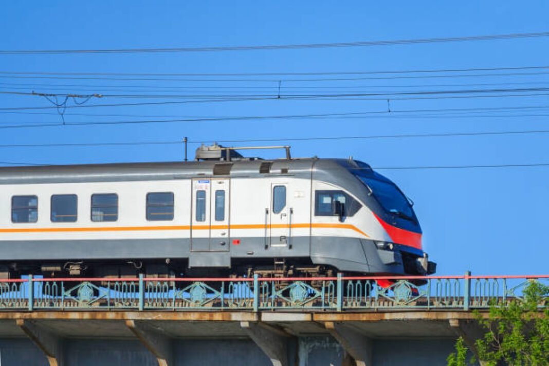 Passenger electric train moves against the clear blue sky Nagawara Metro station, Bengaluru Pink Line, Bangalore Metro Rail Corporation Limited (BMRCL), future Metro extensions