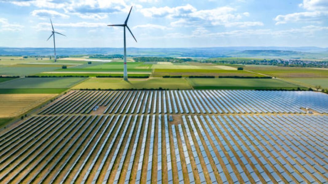 Wind turbines and solar park - aerial view Telecommunications Consultants India Limited (TCIL), renewable energy, clean energy transition, solar power, design and installation, carbon emissions reduction, energy security, sustainable power generation, India’s sustainability goals.