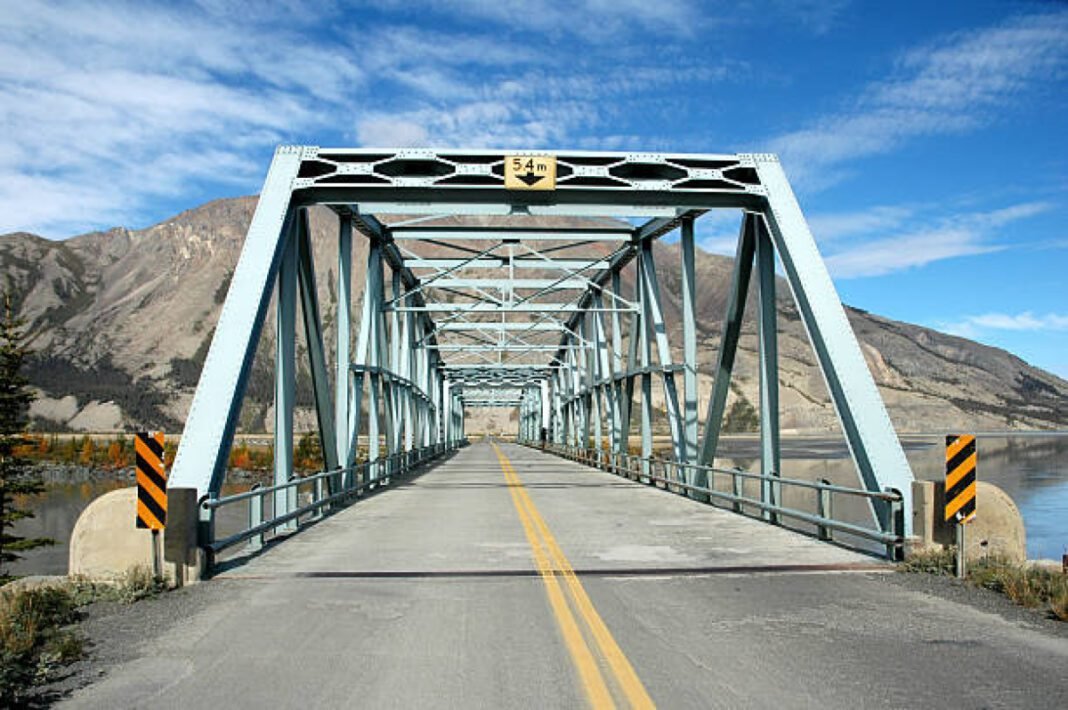 The Slim's River flows into Kluane Lake,Yukon. Assam road infrastructure, Brahmaputra River, Connectivity enhancement, Regional development, Sustainable infrastructure, Bridge construction projects