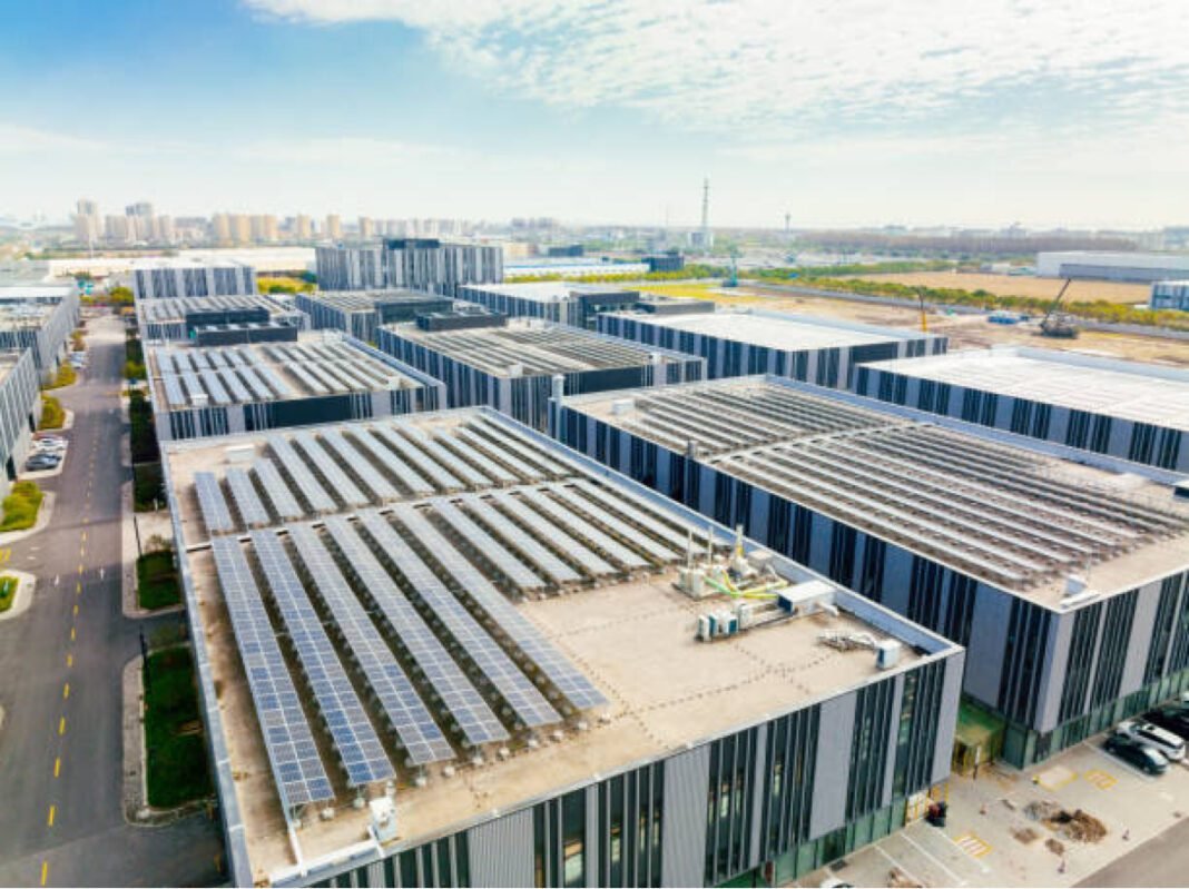 Aerial view of solar panels on factory roof. MEDA, rooftop solar, Maharashtra Energy Development Agency, renewable energy, solar installations, Amravati, Yavatmal, clean energy, tender bids, decentralized power.