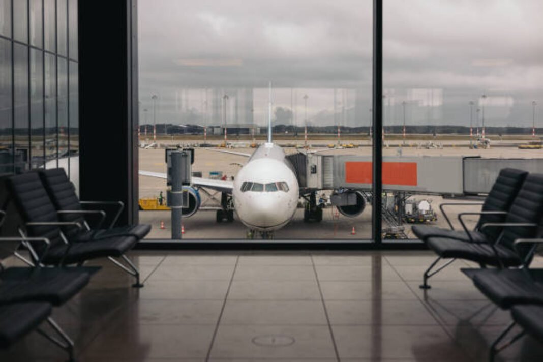 Airplane view from airport lounge in airport termina Navi Mumbai Airport, NMIA, Adani Airports, aviation, greenfield airport, passenger capacity, Mumbai connectivity, modern infrastructure, domestic flights, international flights.