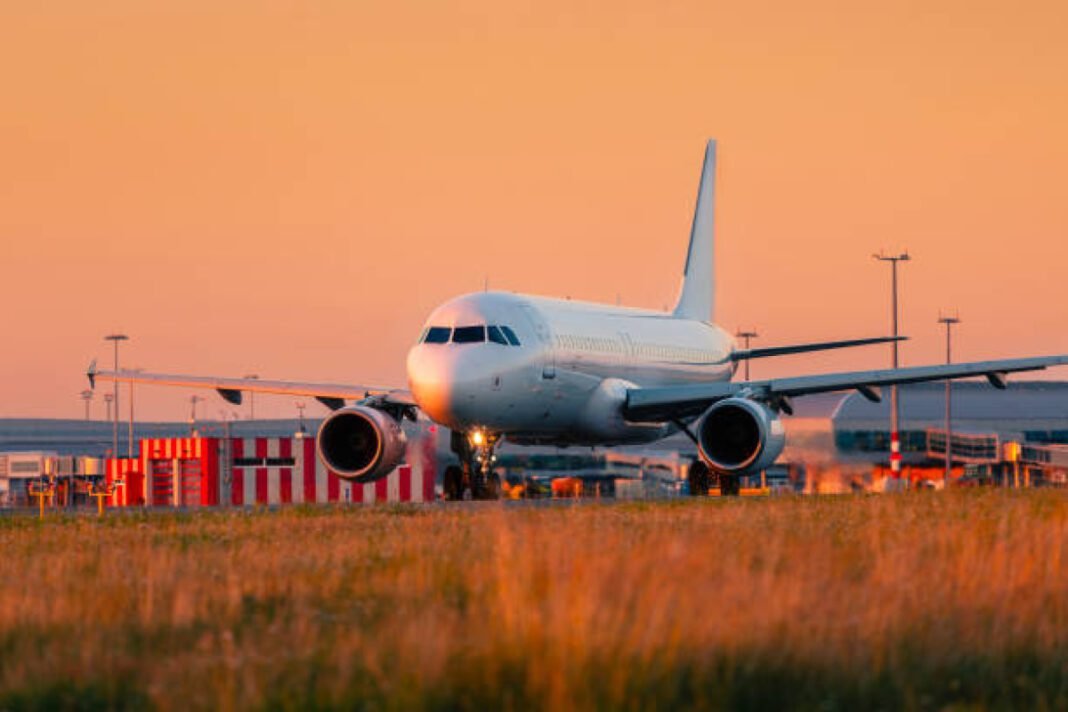 Traffic at airport at golden sunset. Airplane during taking off from runway. Prayagraj Airport, Mahakumbh 2025, airport expansion, flight connectivity, airport modernisation, Civil Aviation, PM Narendra Modi, Ram Mohan Naidu, DGCA