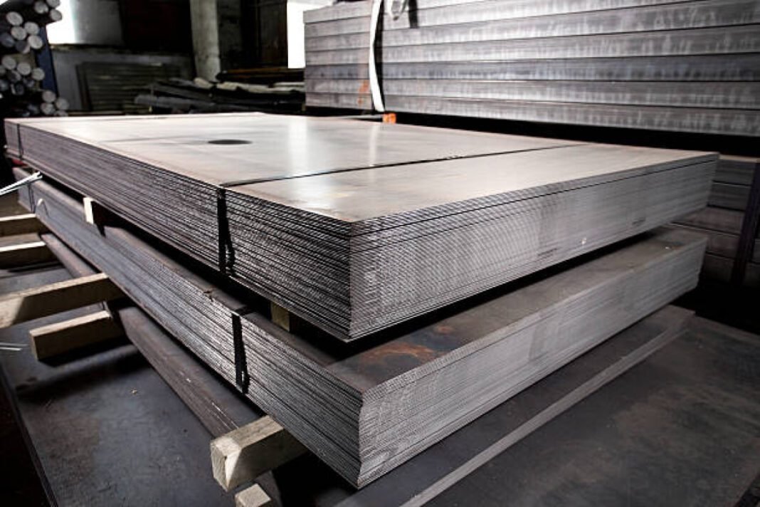 Stainless steel sheets deposited in stacks in a warehouse Interarch, Tata Projects, semiconductor, lithium-ion battery, sustainable energy, pre-engineered steel, Assam, Gujarat
