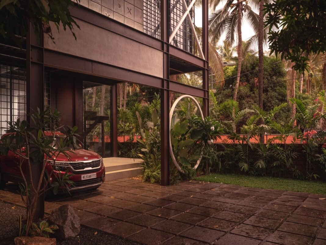 House XO, The XO Factor, industrial design home, contemporary urban living, sustainable home design, steel architecture, modern home Kerala, passive cooling design, prefabricated construction, minimalist architecture, urban loft style, eco-friendly home, steel-framed house, exposed concrete finish, open-plan layout, Kerala architecture, compact home design, sustainable building materials, rapid construction techniques, innovative home design, architectural sustainability